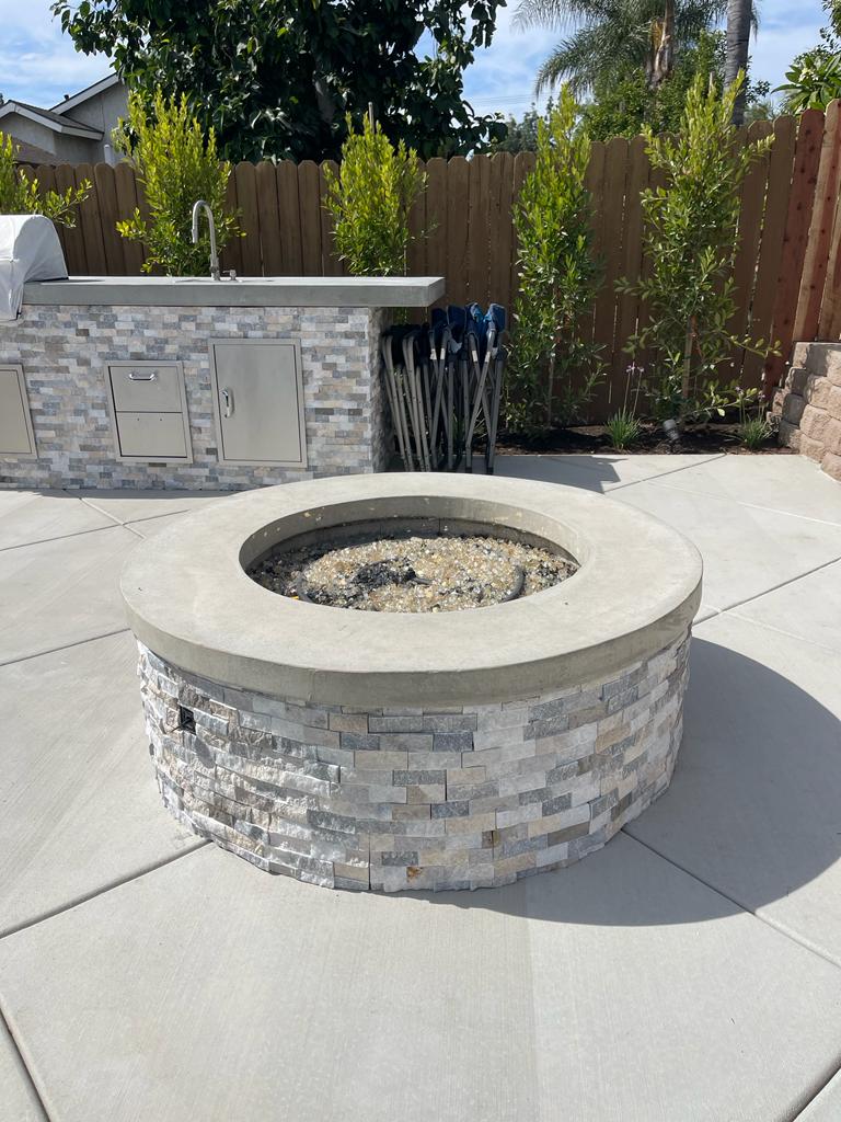 Concrete patio and turf lawn in an Encino outdoor remodel