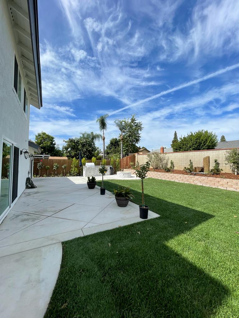 Gas fire pit with stacked-stone surround in an Encino backyard