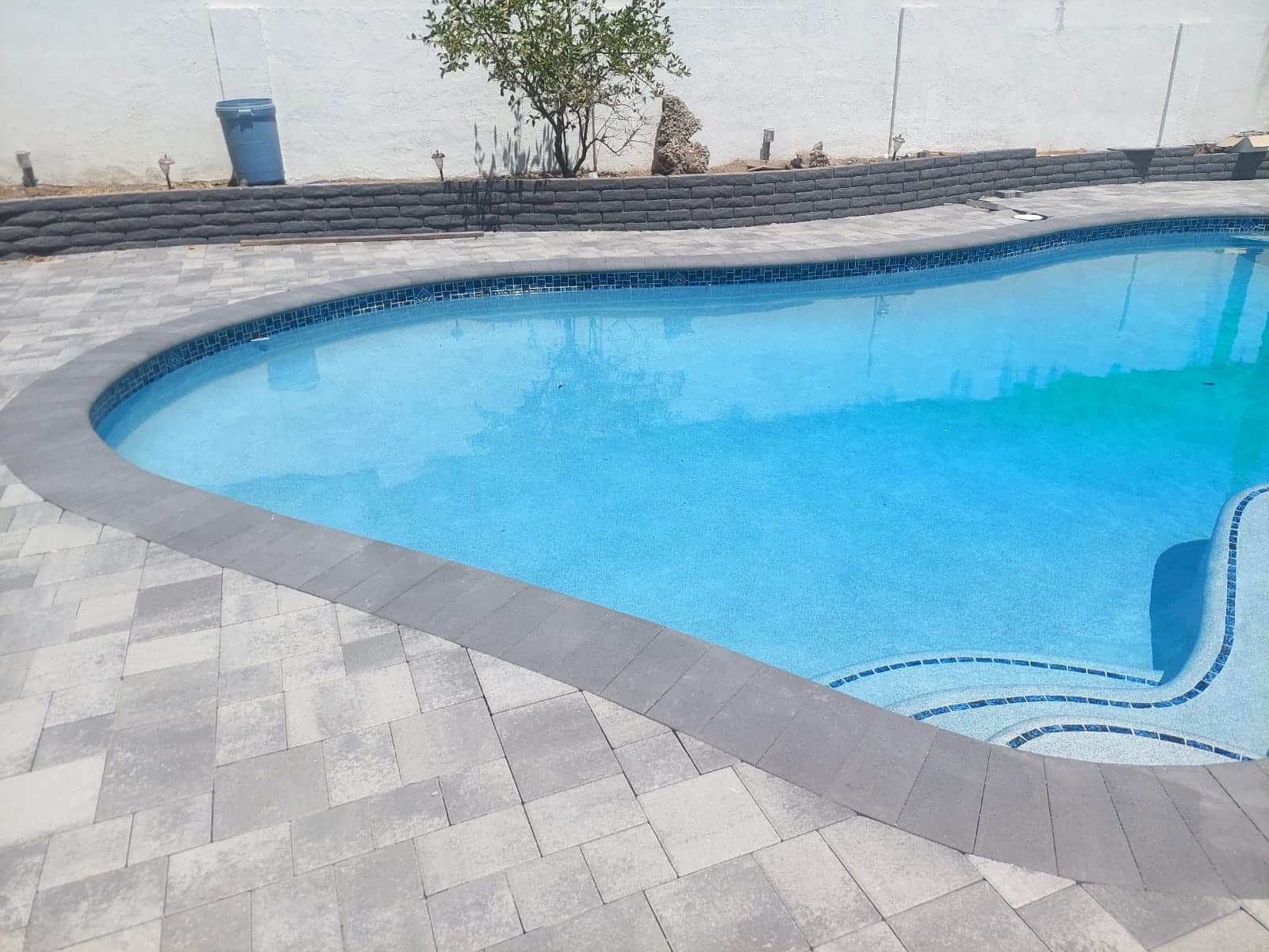 Paver pool deck with charcoal coping in Encino