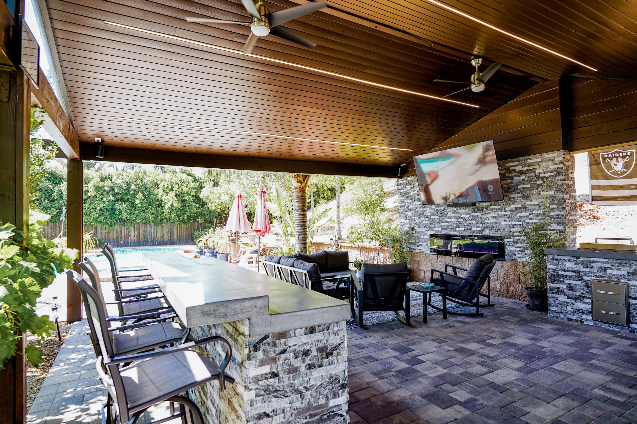 Covered patio with outdoor kitchen and bar seating in Woodland Hills
