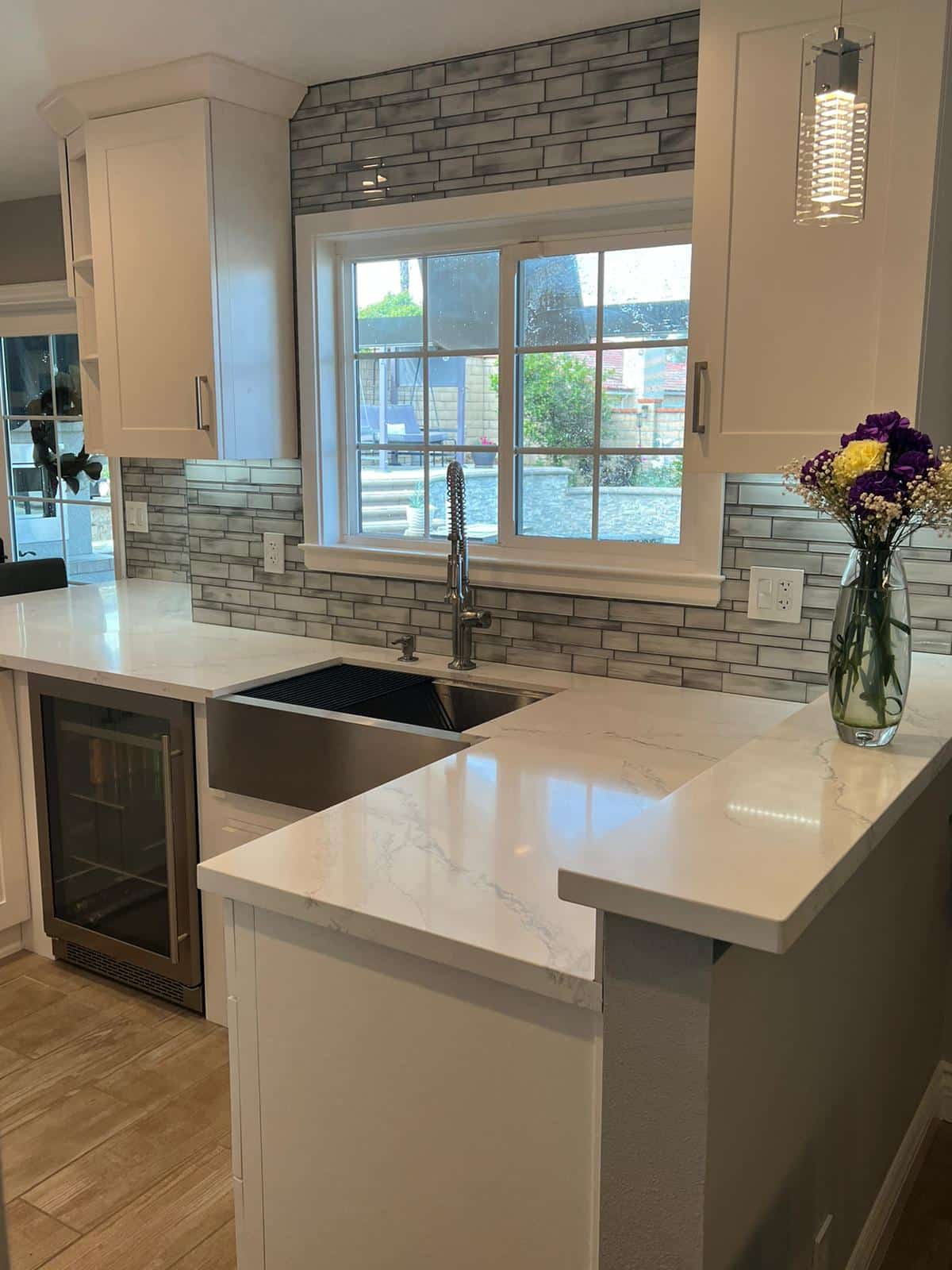 Quartz peninsula and appliance wall in a Sherman Oaks kitchen