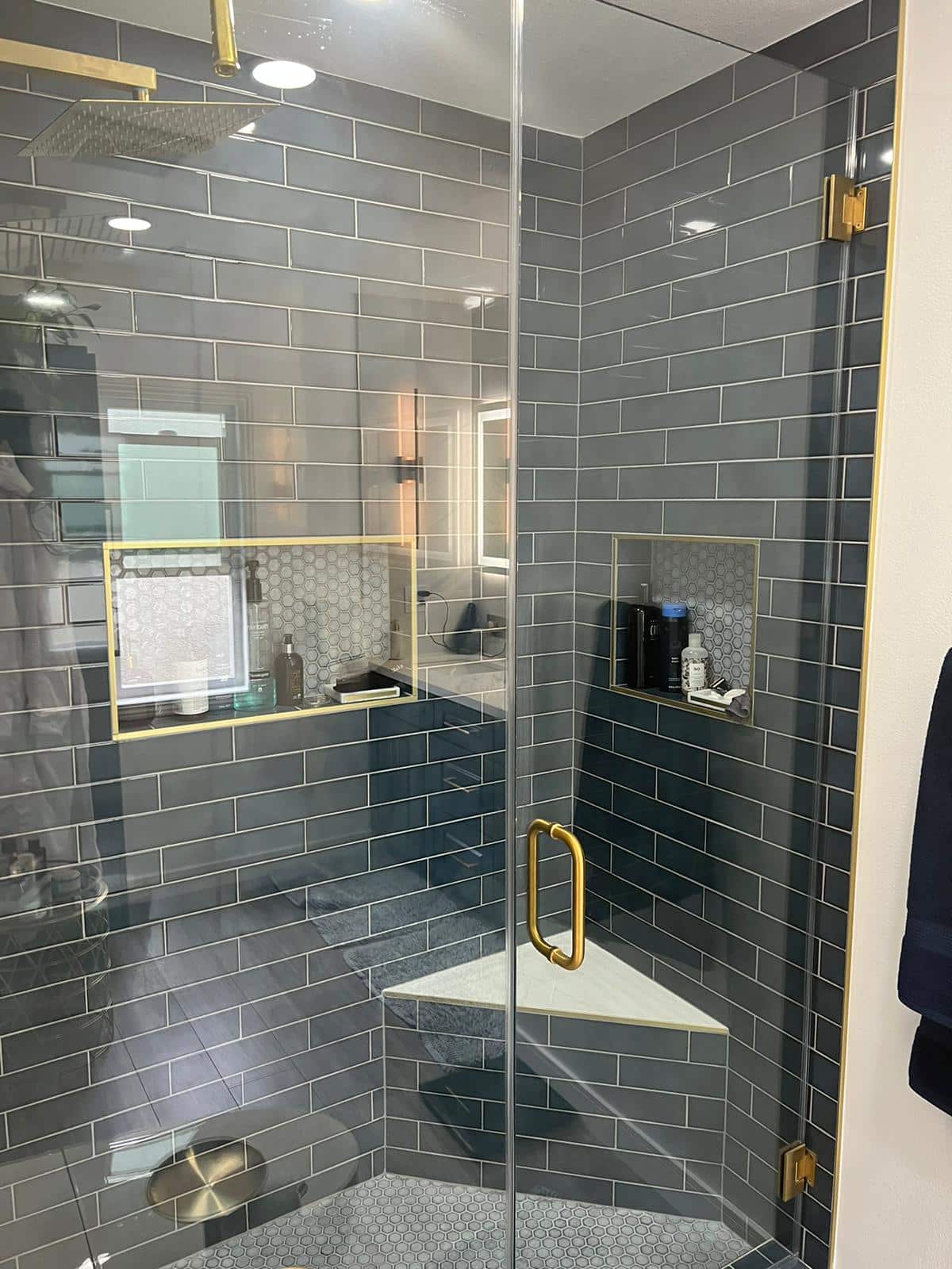Stacked tile shower with brushed gold hardware in Reseda
