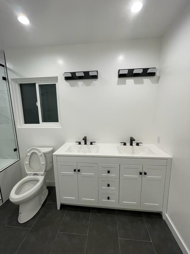 Double vanity with matte black fixtures in Canoga Park