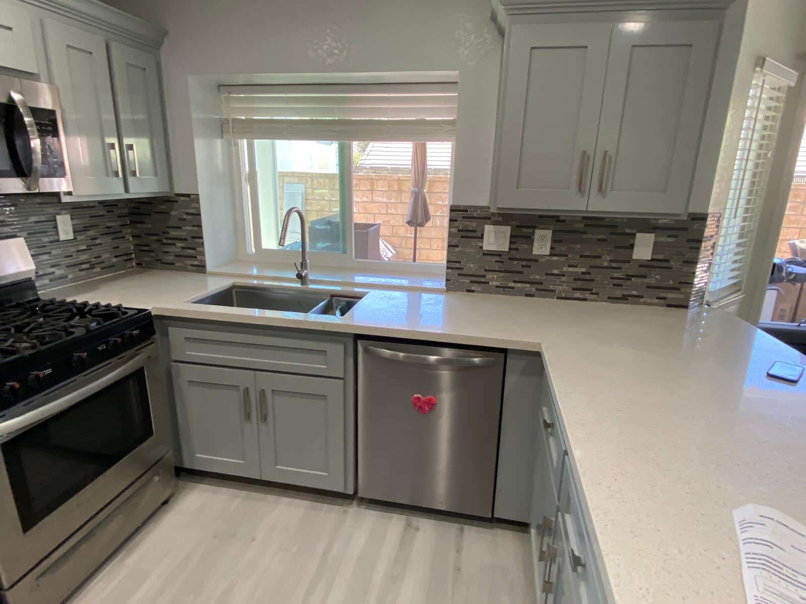 Kitchen after cabinet refacing in light grey shaker in Culver City
